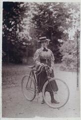 1 vue - [Portrait d\'une jeune femme et de sa bicyclette, dans la cour de la maison Le Casteras]. (ouvre la visionneuse)