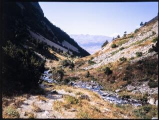 2 vues Une rivière en montagne, avec vue générale sur la vallée.