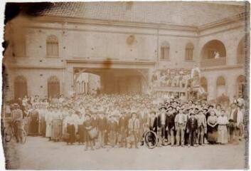1 vue Personnel dans la cour d?honneur de l'usine, l'omnibus à cheval, au balcon on aperçoit une femme tenant un enfant dans les bras.